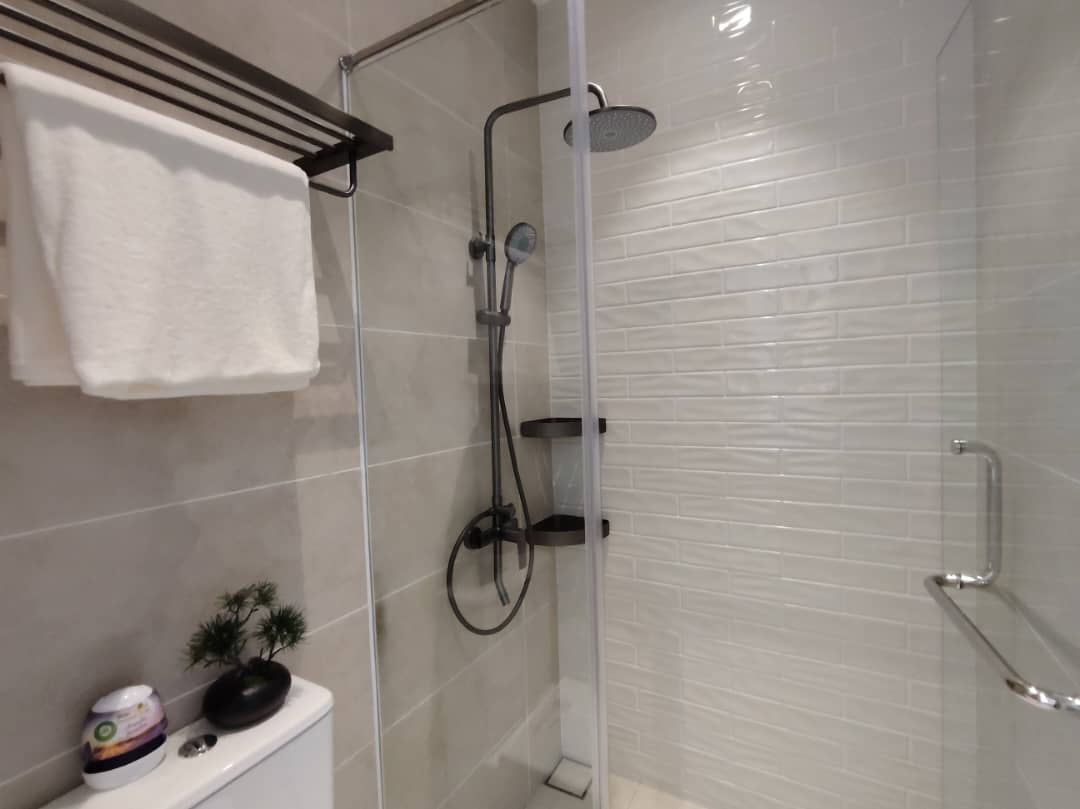 Bathroom with glass shower enclosure and subway tile