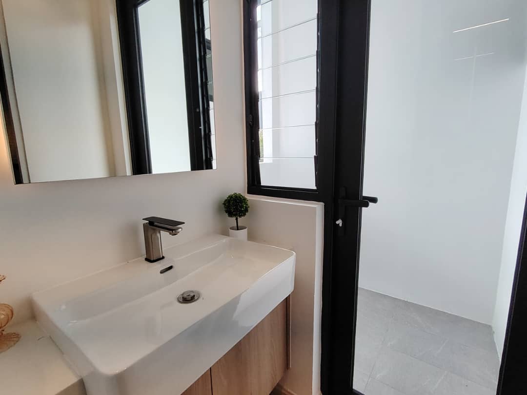 Bathroom vanity with vessel sink and black-framed mirror