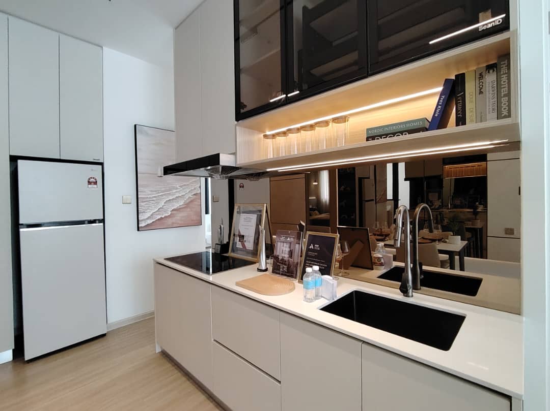 Modern kitchen with black upper cabinets and mirror backsplash